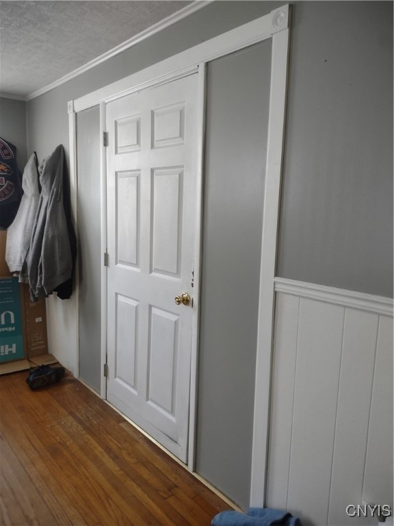 mudroom with a textured ceiling, dark hardwood / wood-style floors, and ornamental molding