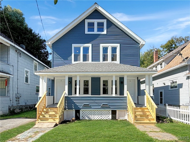 view of front of house with a front lawn and covered porch