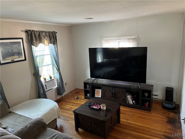 living room with ornamental molding, cooling unit, baseboard heating, and hardwood / wood-style floors