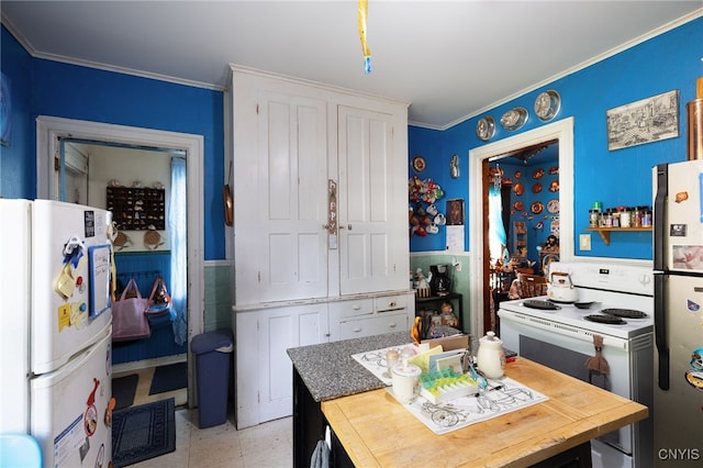 kitchen featuring white cabinets, white appliances, and crown molding