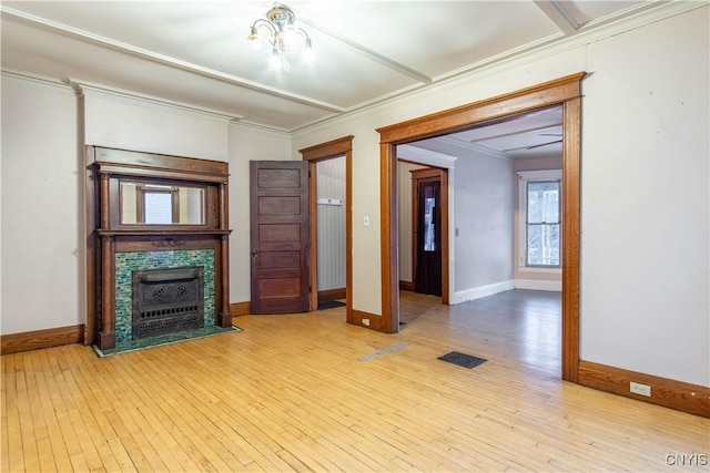 unfurnished living room featuring crown molding, a notable chandelier, and light wood-type flooring