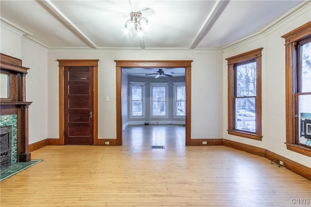 unfurnished living room featuring light hardwood / wood-style floors, ceiling fan with notable chandelier, and ornamental molding