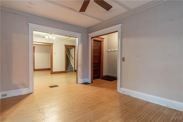 empty room featuring crown molding, ceiling fan, and light hardwood / wood-style floors