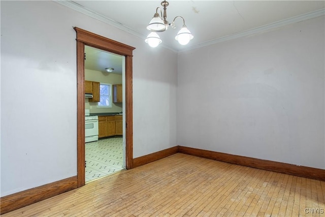 unfurnished room with ornamental molding, light wood-type flooring, and a notable chandelier