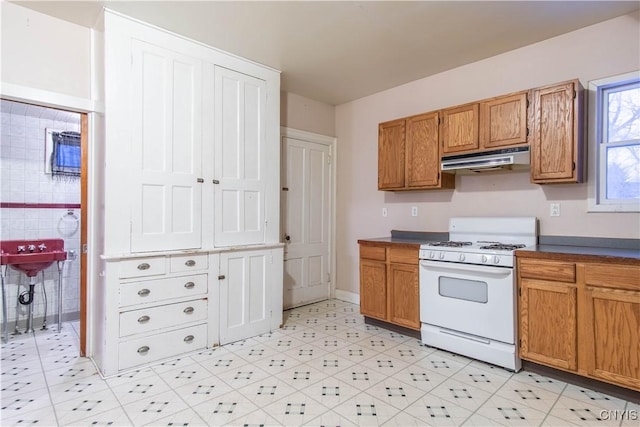 kitchen with white range with gas stovetop