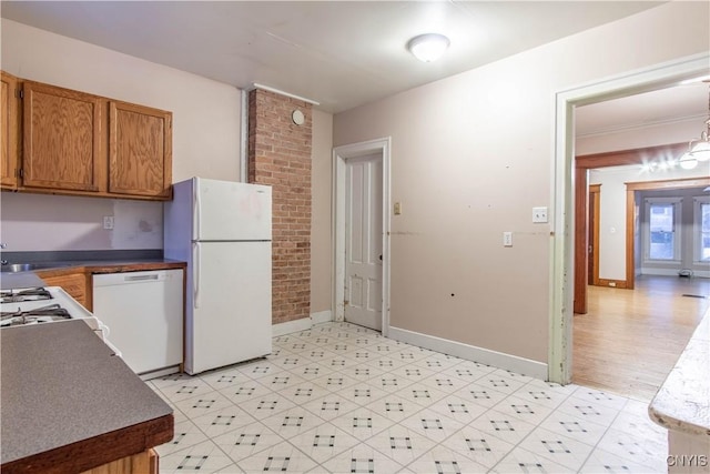 kitchen featuring white appliances and light hardwood / wood-style flooring