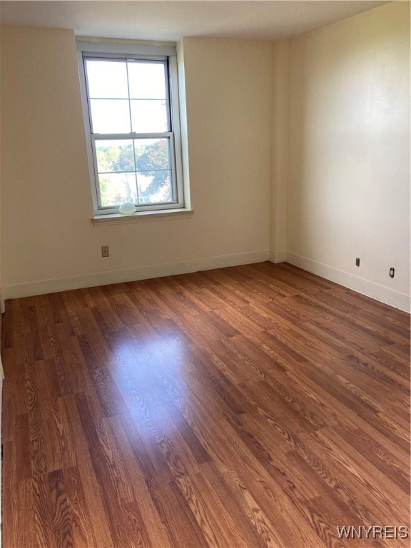 unfurnished room featuring dark hardwood / wood-style floors