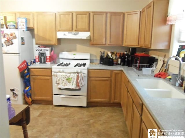 kitchen featuring white appliances and sink