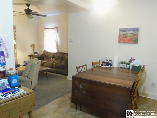 carpeted dining space with ceiling fan