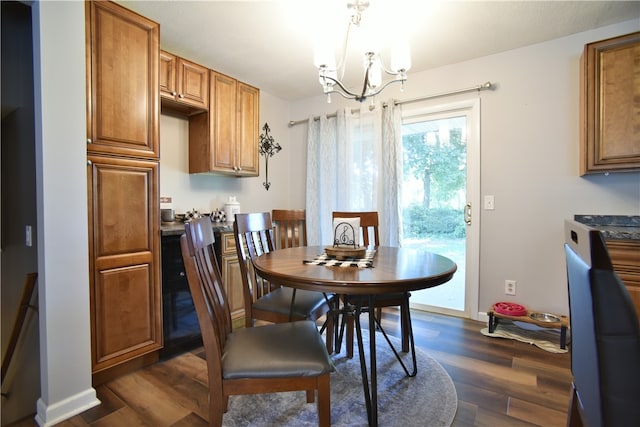 dining area featuring dark hardwood / wood-style flooring and a chandelier