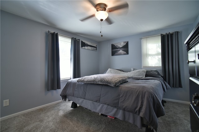 carpeted bedroom featuring ceiling fan