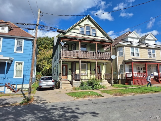 view of front of property featuring a balcony and covered porch