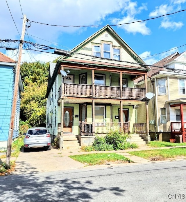 view of front of home with a balcony and a porch