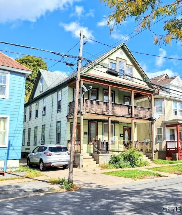 view of front of property with a balcony and a porch