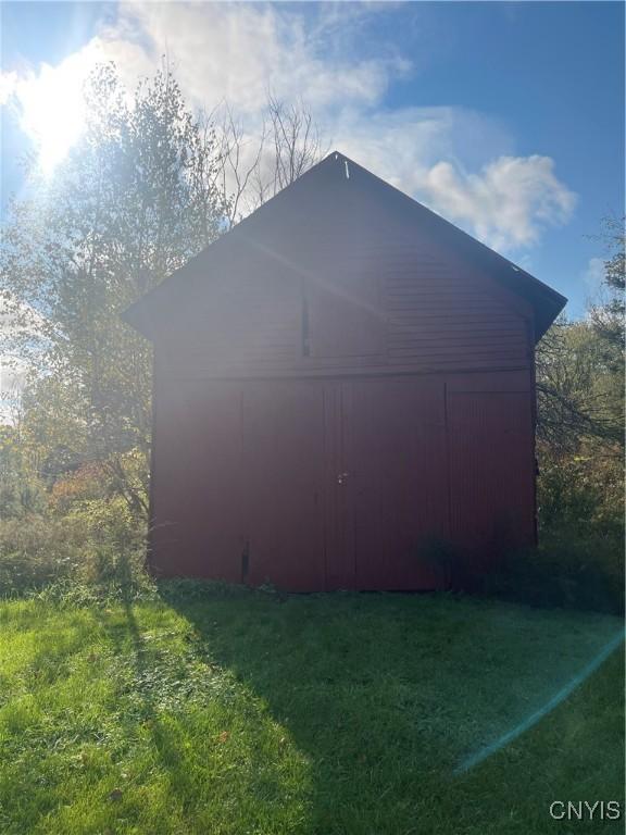 view of outbuilding featuring a lawn