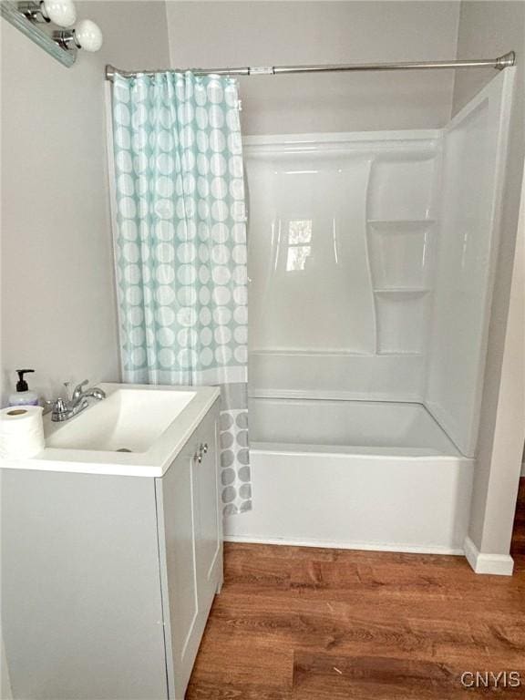 bathroom featuring sink, shower / bath combination with curtain, and hardwood / wood-style flooring