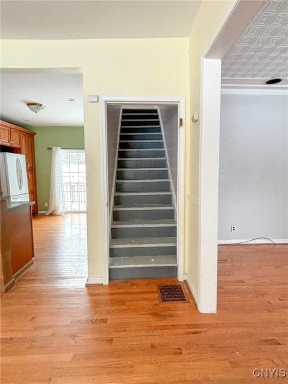 stairs featuring hardwood / wood-style flooring