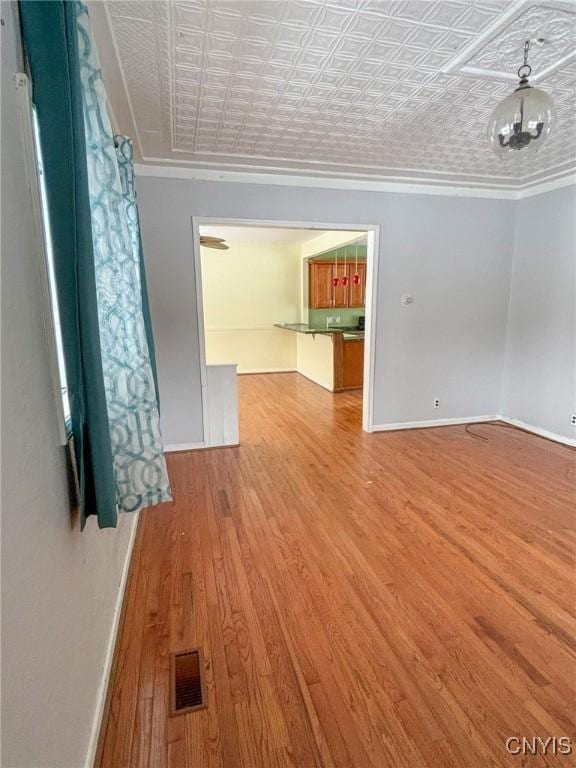 interior space with hardwood / wood-style flooring and crown molding