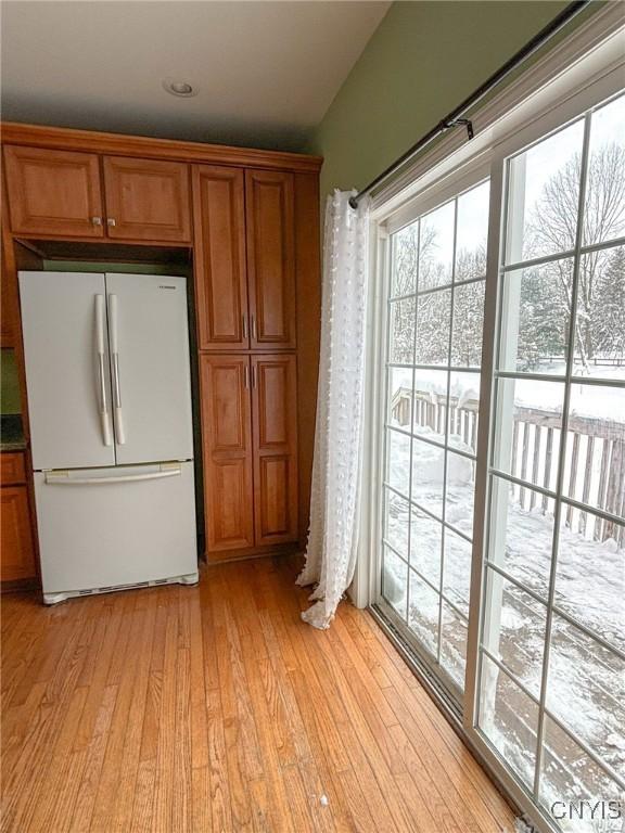 kitchen featuring light wood-type flooring and white fridge