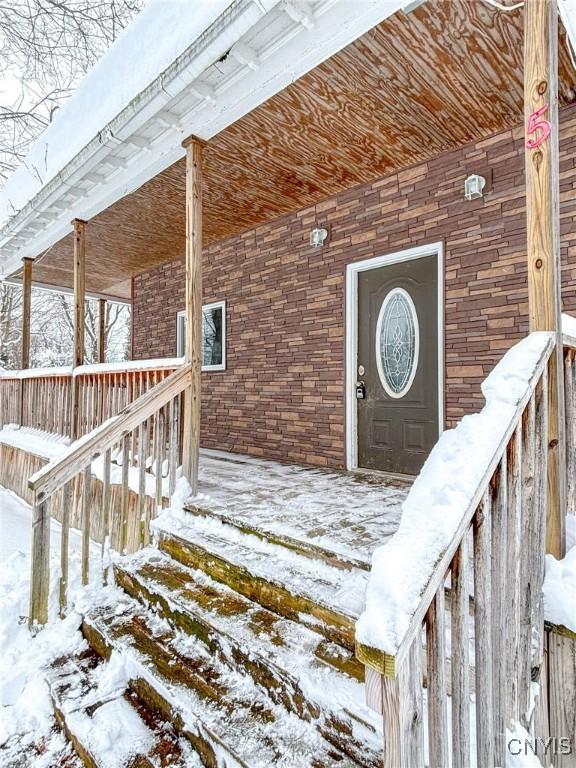 view of snow covered property entrance