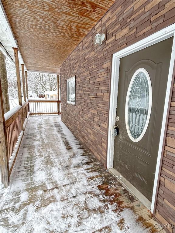 view of exterior entry with covered porch