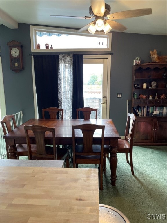 dining room featuring carpet flooring, lofted ceiling, and ceiling fan