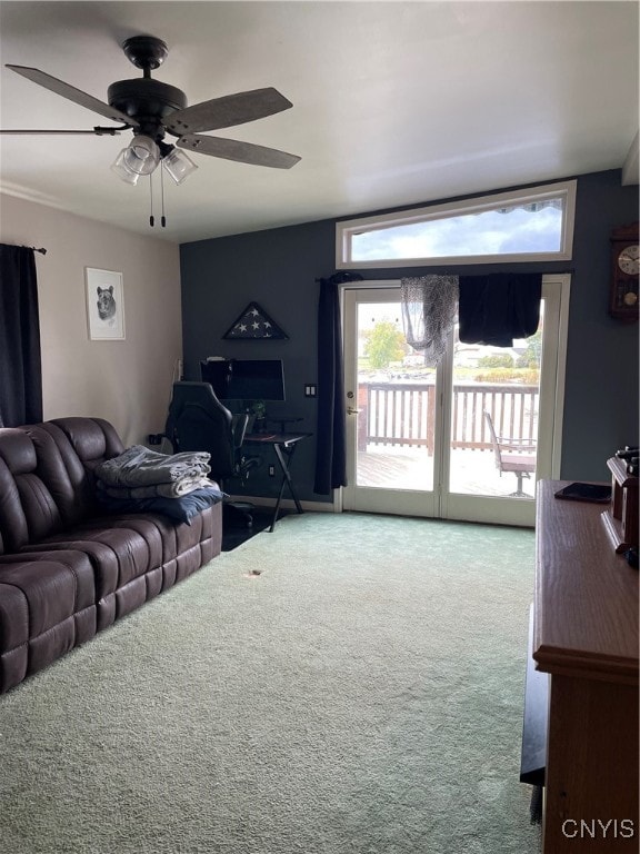 carpeted living room featuring ceiling fan