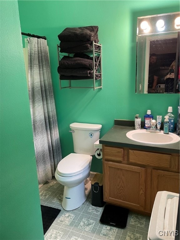 bathroom featuring vanity, toilet, and a shower with shower curtain