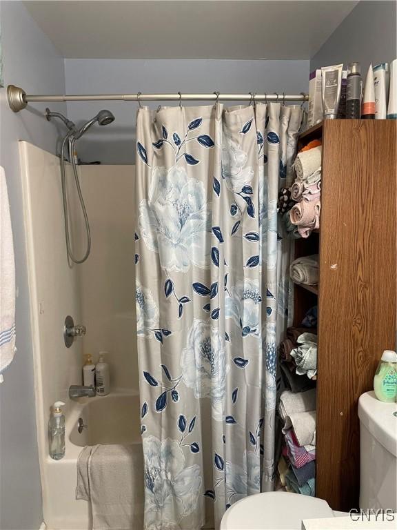 28541 Hewitt Dr, Lyme, NY 13622 - full bathroom with toilet and shower / bathtub combination with curtain