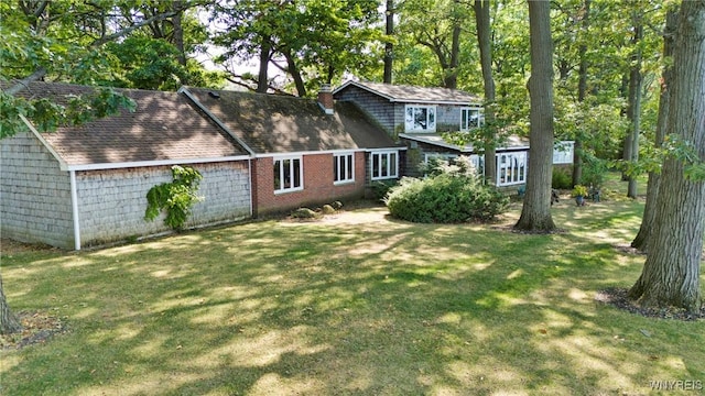 rear view of property with a lawn