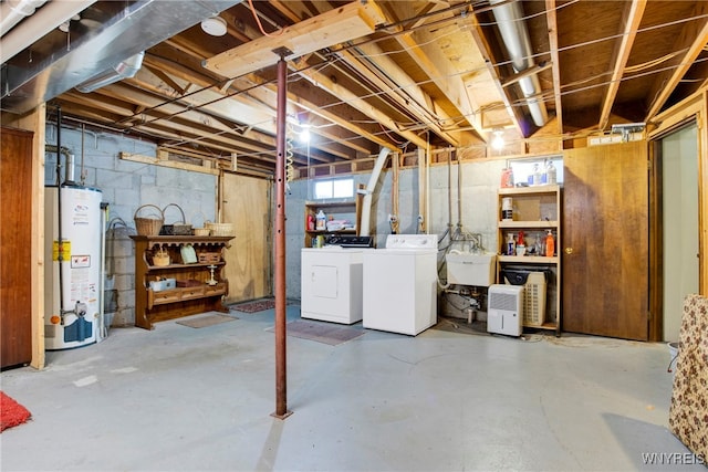 basement with washer and clothes dryer, sink, and water heater