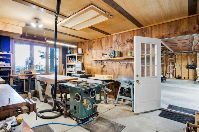 interior space featuring a workshop area and wooden walls