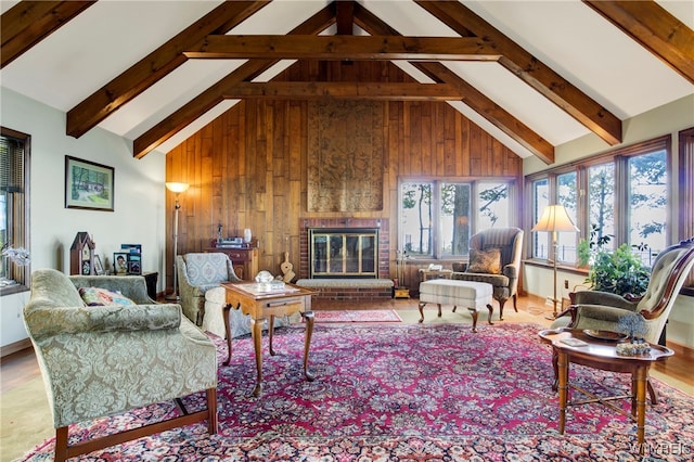 living room with a fireplace, high vaulted ceiling, beamed ceiling, and wood walls