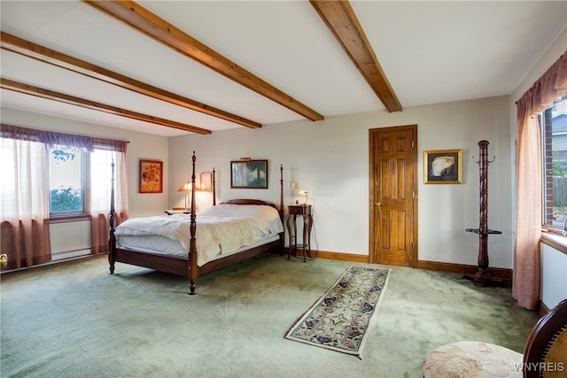 carpeted bedroom with beam ceiling