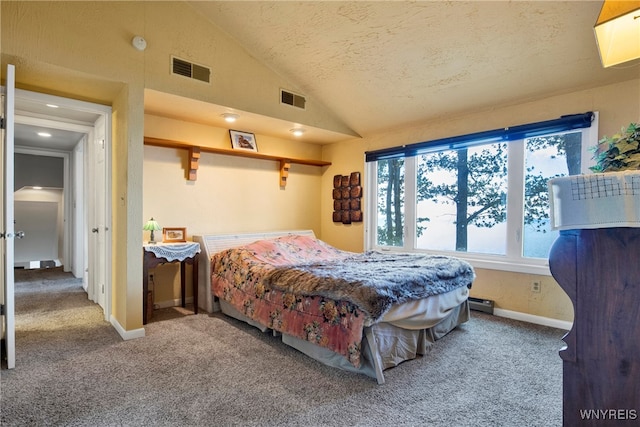 bedroom featuring lofted ceiling, carpet, and a textured ceiling