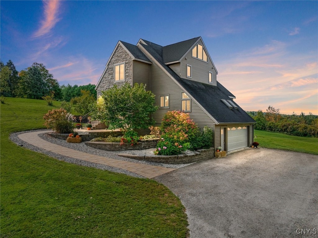 property exterior at dusk with a yard