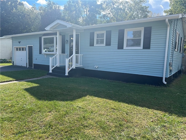 manufactured / mobile home with a garage and a front lawn