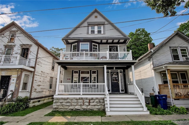 view of front facade with a balcony and a porch