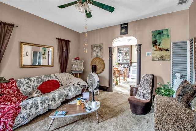 living room with light carpet and ceiling fan