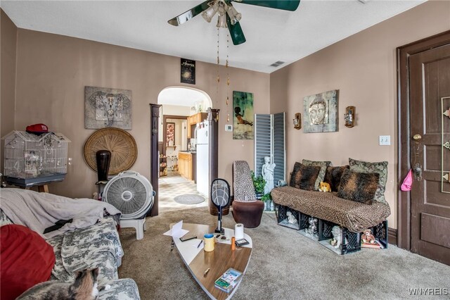 living room with carpet and ceiling fan