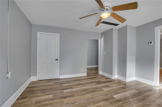 unfurnished room featuring ceiling fan and hardwood / wood-style floors