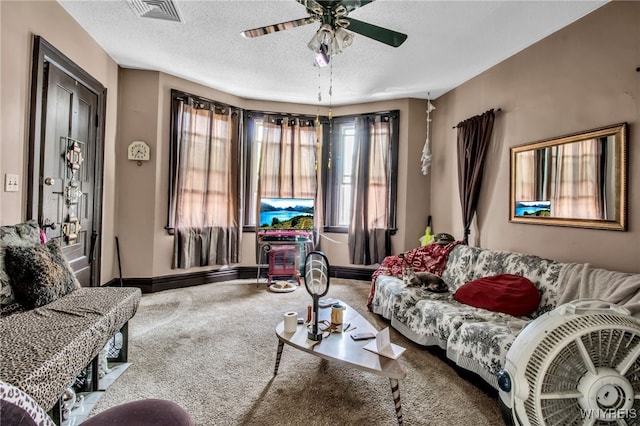 carpeted living room featuring a textured ceiling and ceiling fan