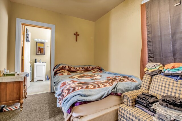 carpeted bedroom with ensuite bath