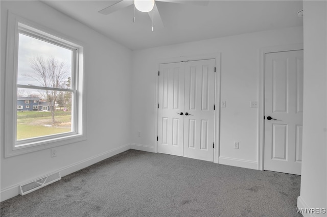 unfurnished bedroom with carpet flooring and ceiling fan