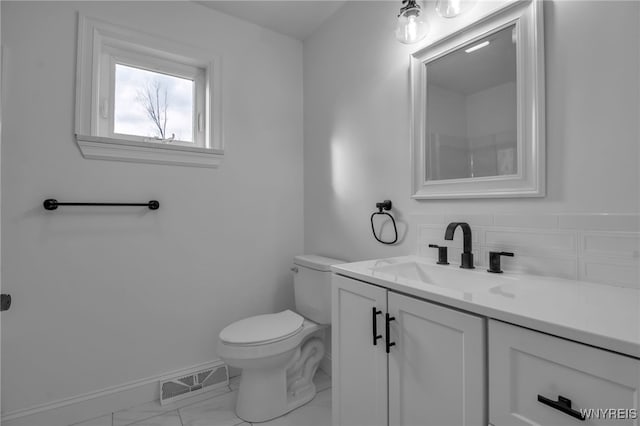 bathroom featuring vanity and toilet