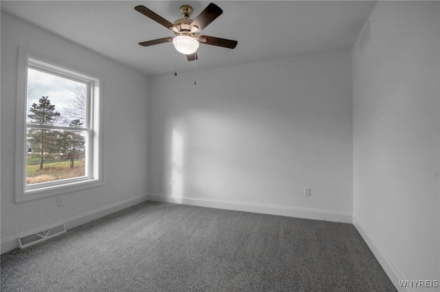 carpeted spare room with ceiling fan