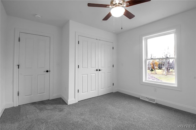 unfurnished bedroom with ceiling fan and carpet