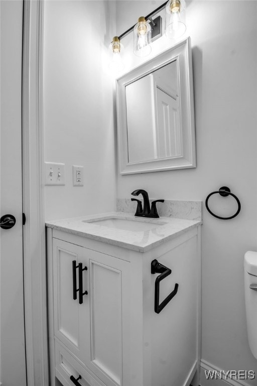 bathroom with vanity and toilet