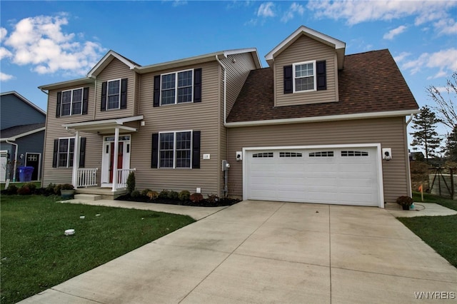 view of front of house featuring a garage and a front lawn