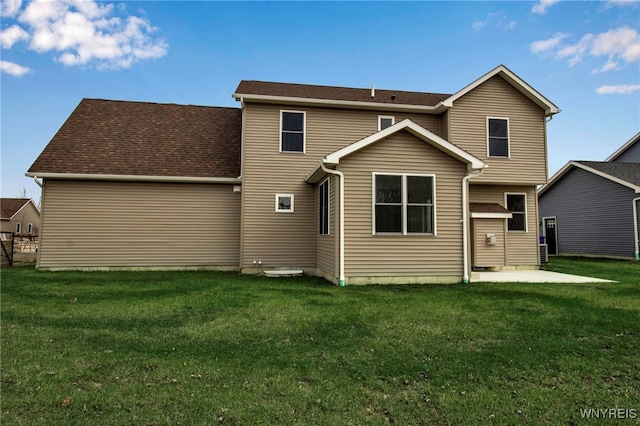 back of house with a patio and a lawn